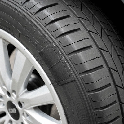 Close-up of a tire with a patch, demonstrating a professional repair